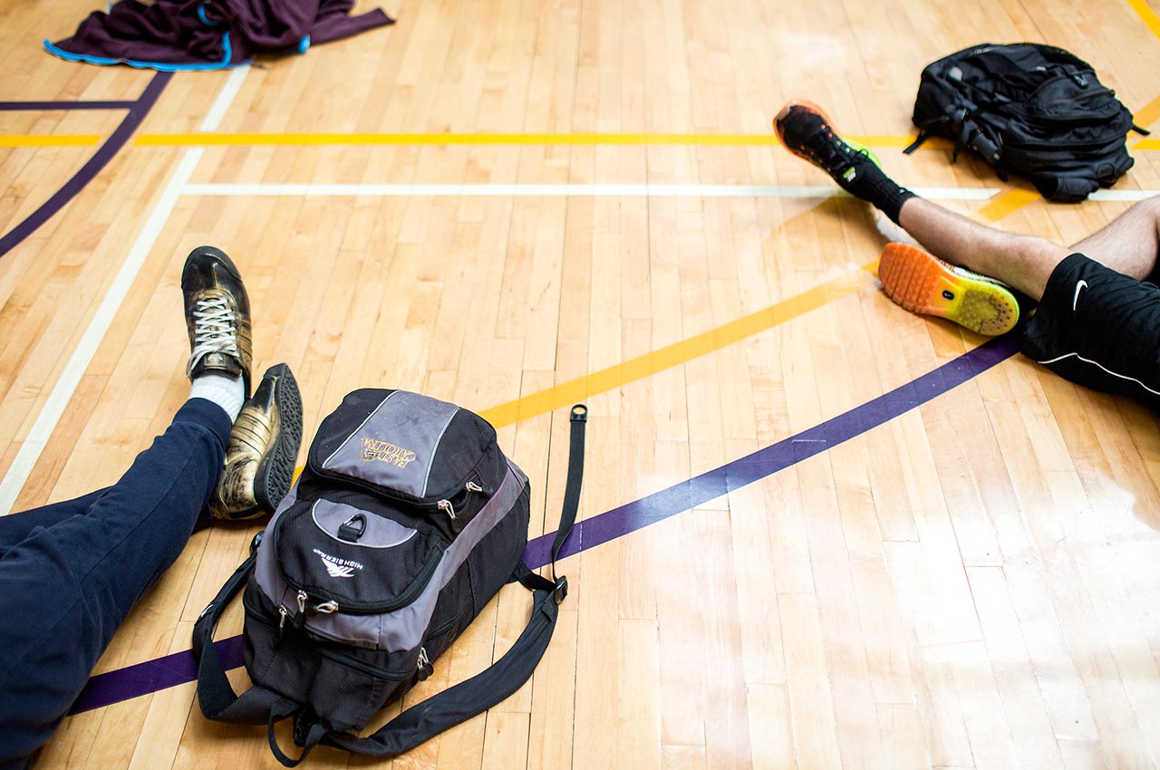 Students sitting on the gym floor